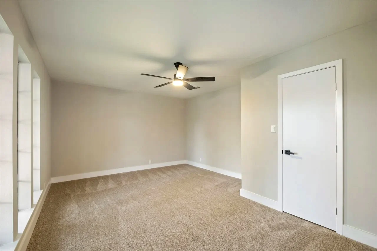 New bedroom addition with carpet, neutral paint, ceiling fan, and a full-height closet in Fort Worth, Texas.
