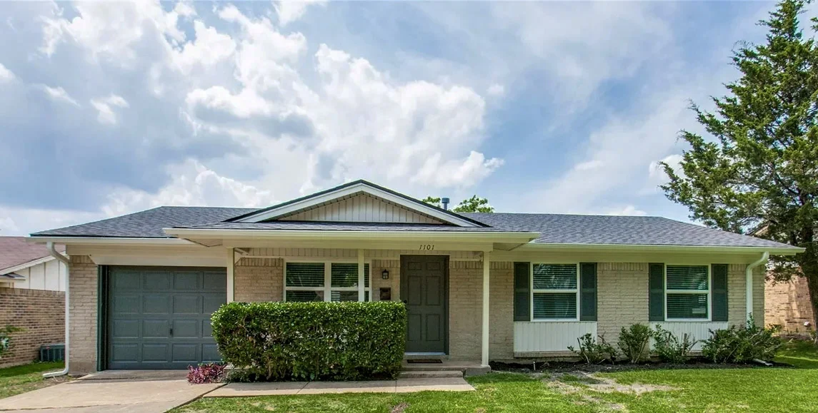 Single-story Garland ranch exterior with replacement windows, light siding, attached garage, and mature landscaping in Garland, Texas.