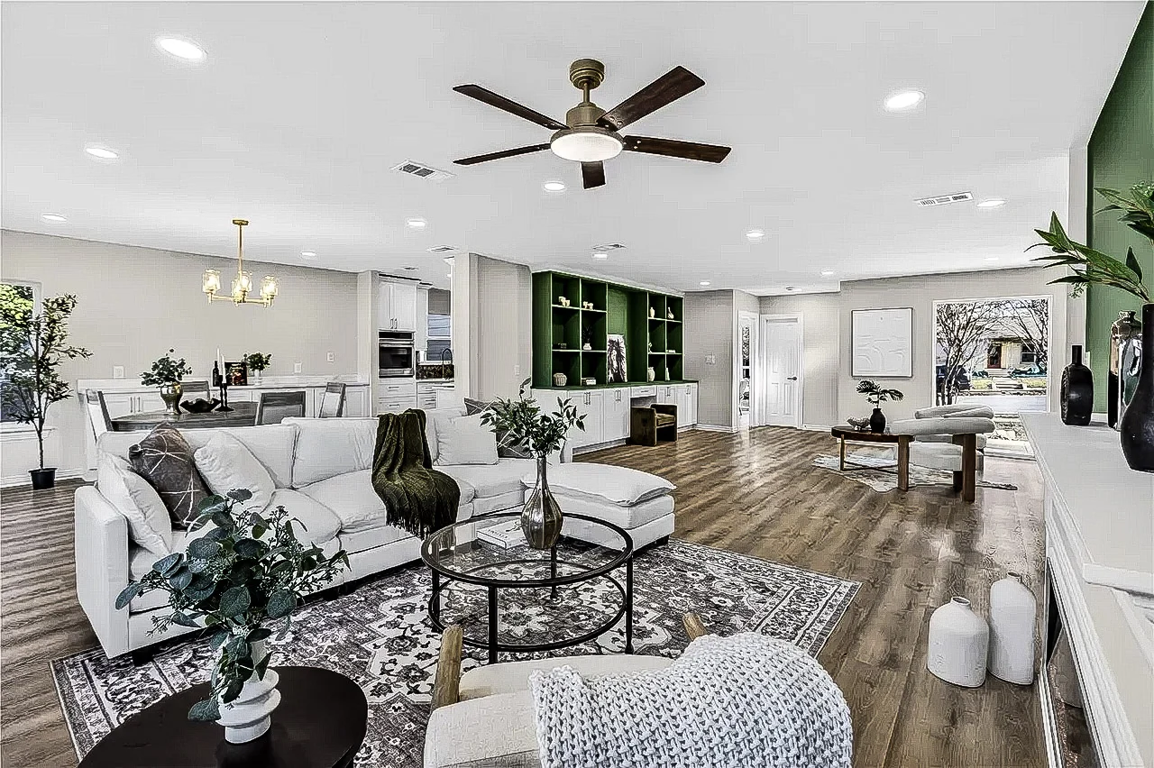 Open living room with deep green custom built-ins, white lower cabinetry, light flooring, large windows, and staged furnishings in Lakewood, Dallas, Texas.